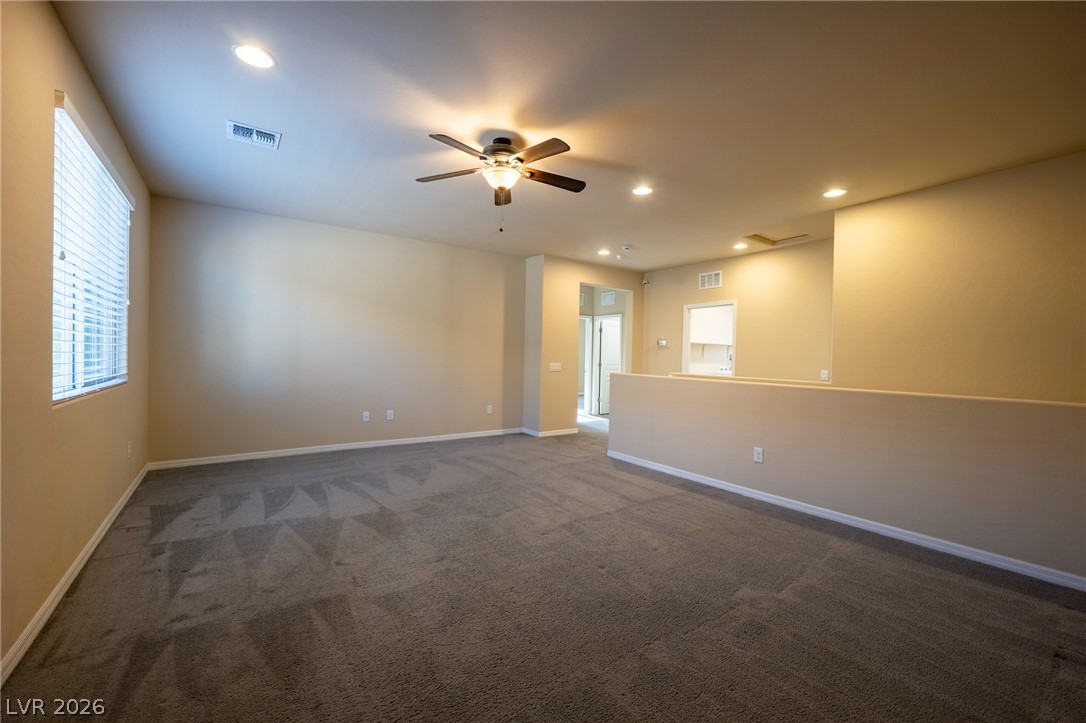 11016 Prairie Grove Road Las Vegas, NV 89179 - Photo 18 of 37 Well-lit and versatile, this spacious bonus room features soft carpeting and ample overhead lighting.