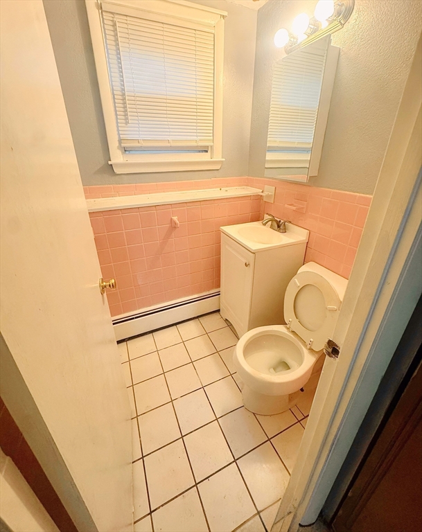 6 A Maynard Street, Unit A Boston, MA 02131 - Photo 12 of 12 a bathroom with a granite countertop sink toilet and mirror
