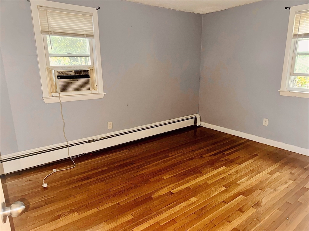 6 A Maynard Street, Unit A Boston, MA 02131 - Photo 3 of 12 a room with hard wood floors and a window