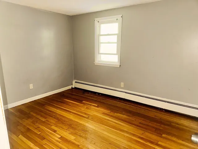 a room with a wooden floor and fan