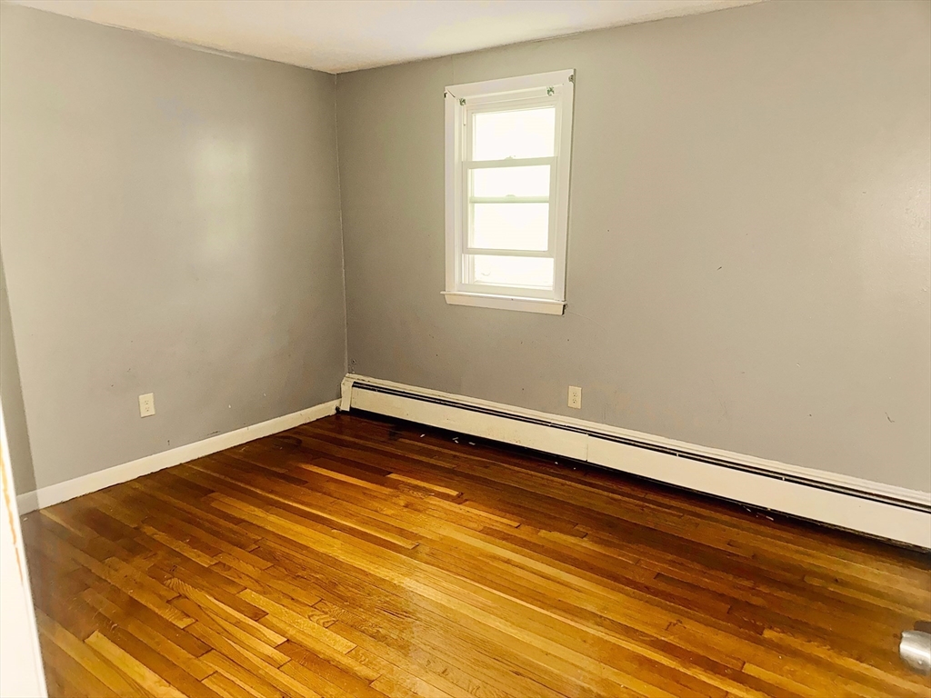 6 A Maynard Street, Unit A Boston, MA 02131 - Photo 4 of 12 a room with a wooden floor and fan