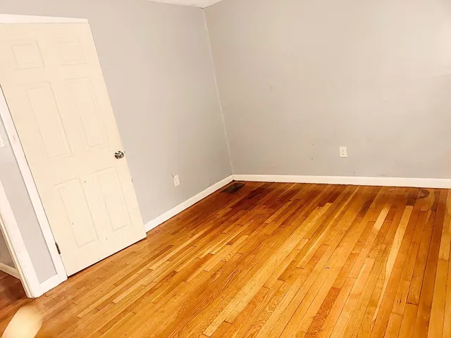 a view of a room with wooden floor
