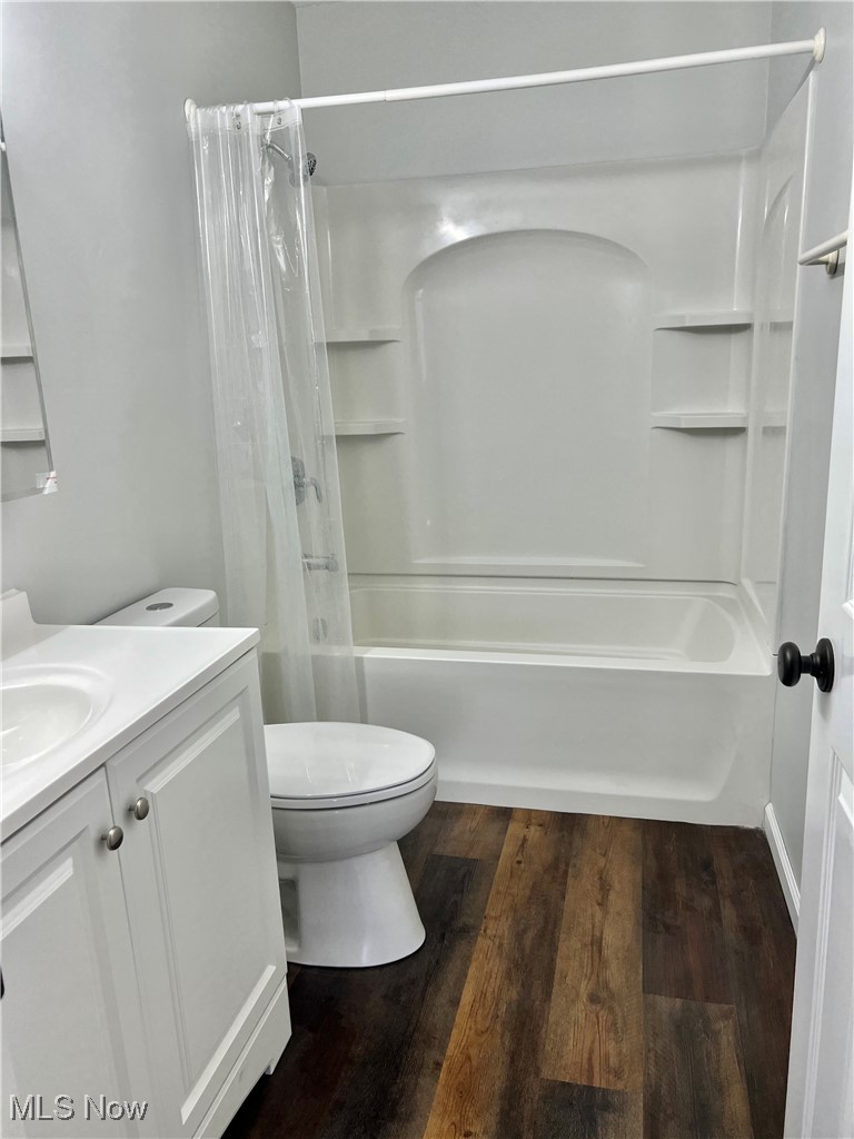 15317 Strader Road East Liverpool, OH 43920 - Photo 16 of 23 Full bathroom with shower / bathtub combination with curtain, vanity, wood-type flooring, and toilet