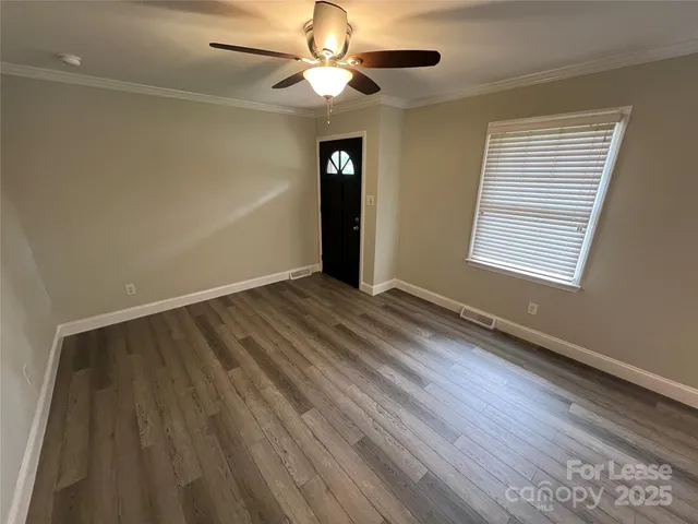wooden floor in an empty room with a window