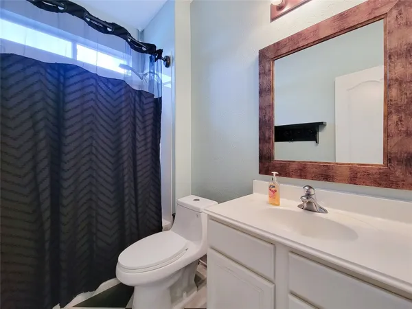 a bedroom with a bed and a television