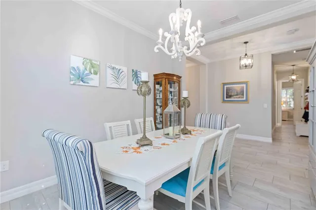 a kitchen with refrigerator cabinets dining table and chairs