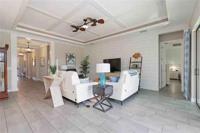 a kitchen with stainless steel appliances a table chairs microwave and refrigerator