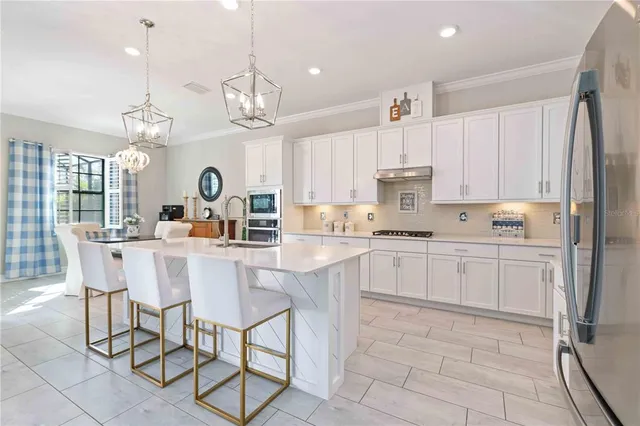 a dining room with furniture a chandelier and wooden floor