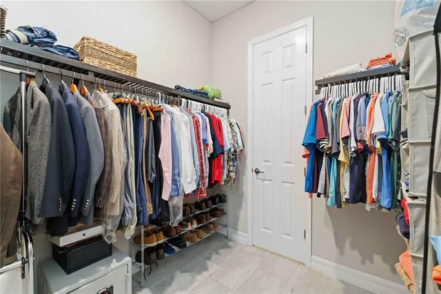 a spacious bathroom with a granite countertop sink mirror and a bathtub