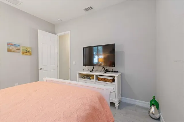 a spacious bathroom with a double vanity sink a large mirror a shower and vanity