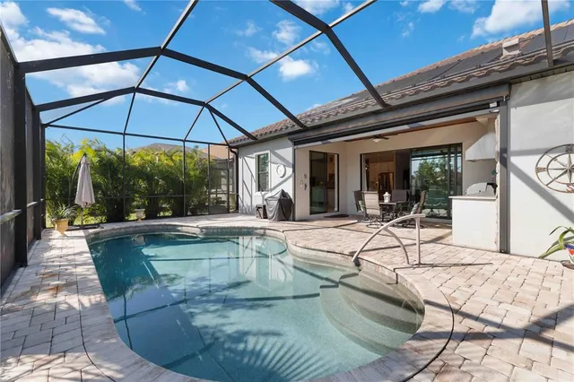 an aerial view of residential house with outdoor space and swimming pool