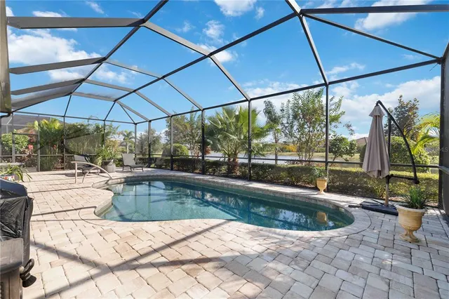 an aerial view of residential houses with outdoor space and river