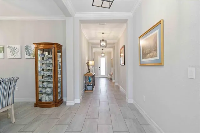 a view of a dining room with furniture a chandelier and wooden floor