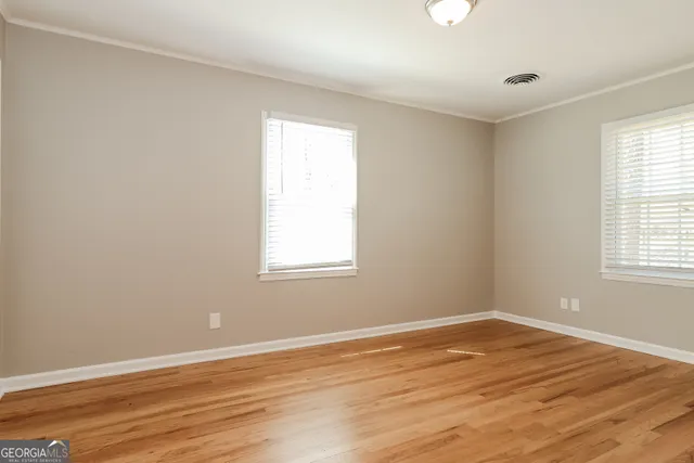 wooden floor in an empty room with a window