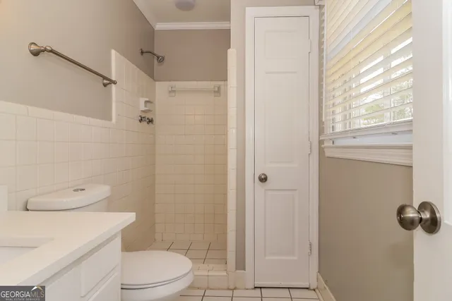 a bathroom with a toilet a sink and shower
