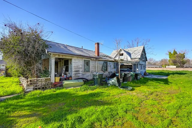 a view of a house with backyard porch and sitting area