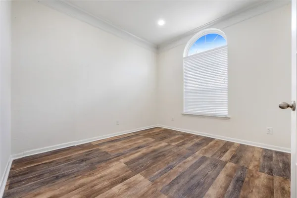 a kitchen with stainless steel appliances granite countertop a stove top oven a sink a refrigerator and white cabinets