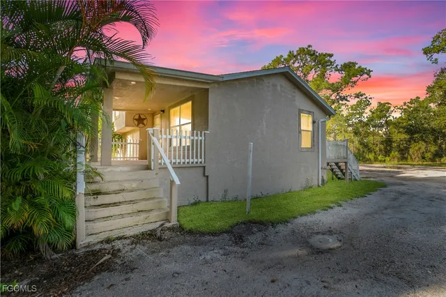 a front view of a house with a garden
