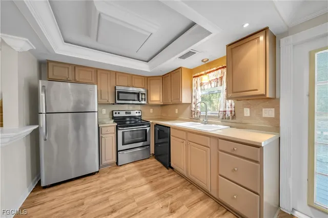 a kitchen with stainless steel appliances granite countertop a refrigerator stove a sink dishwasher and microwave