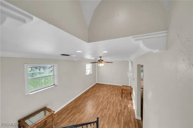 a view of empty room with wooden floor