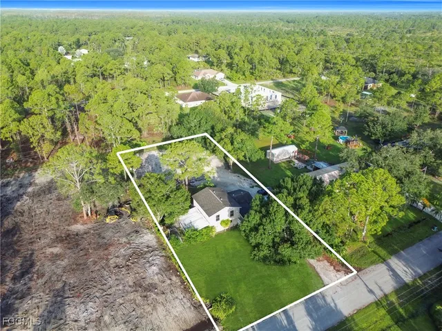 a view of a yard with potted plants