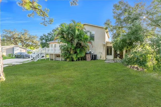 a view of house with backyard