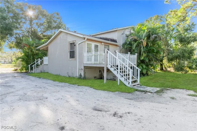 a view of a house with a yard and a patio