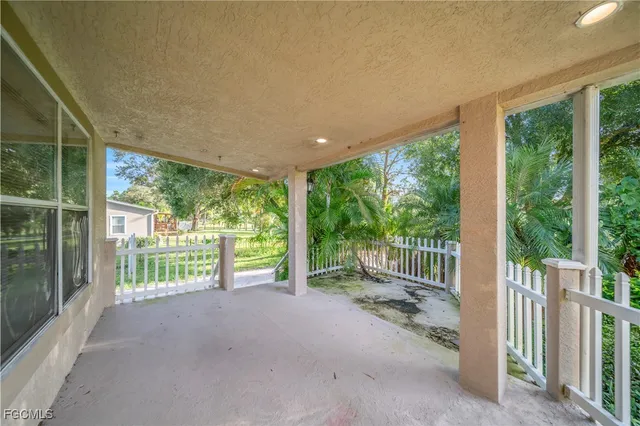 a view of a room with wooden floor and iron fence