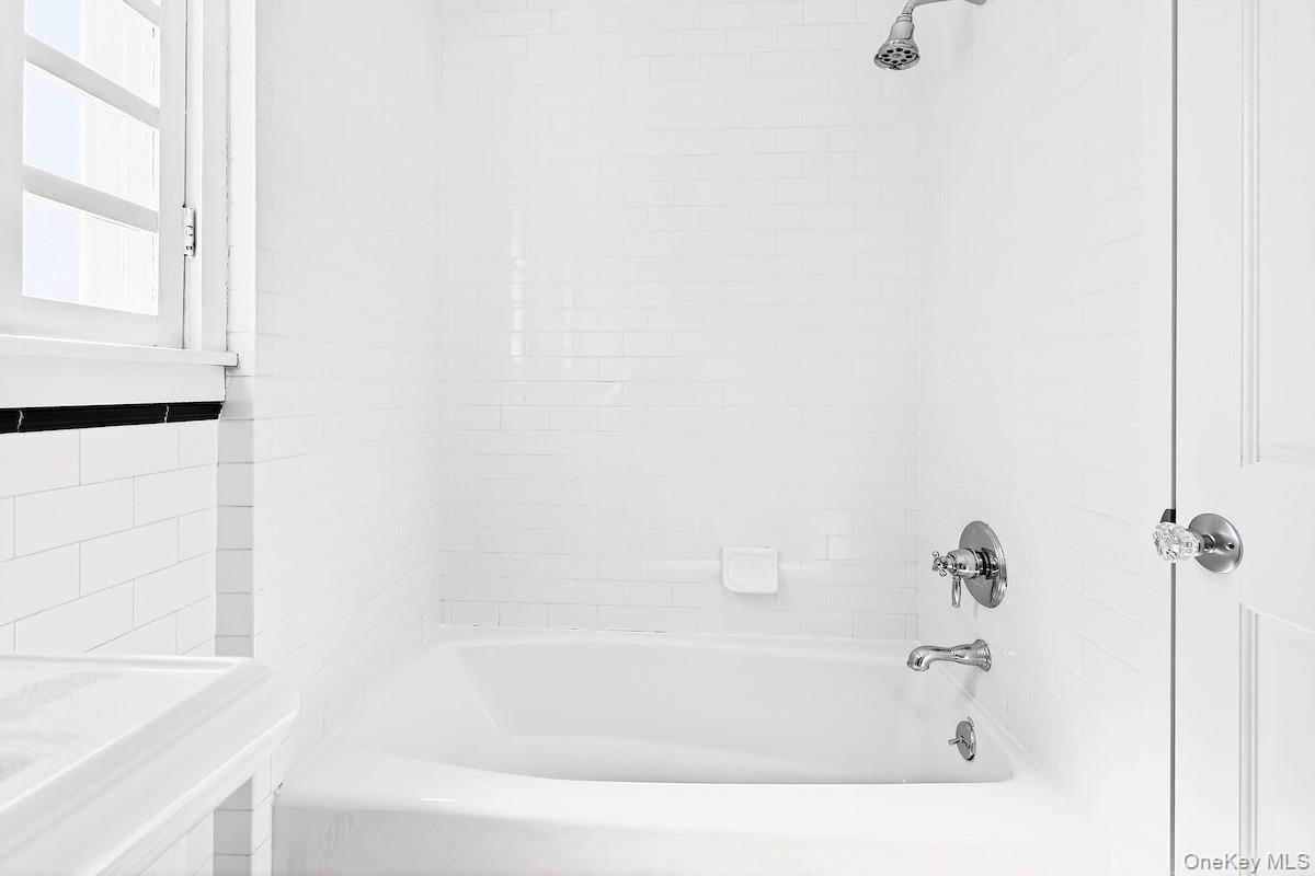48 Fenwick Road Hastings-on-Hudson, NY 10706 - Photo 24 of 40 a white bath tub sitting next to a window