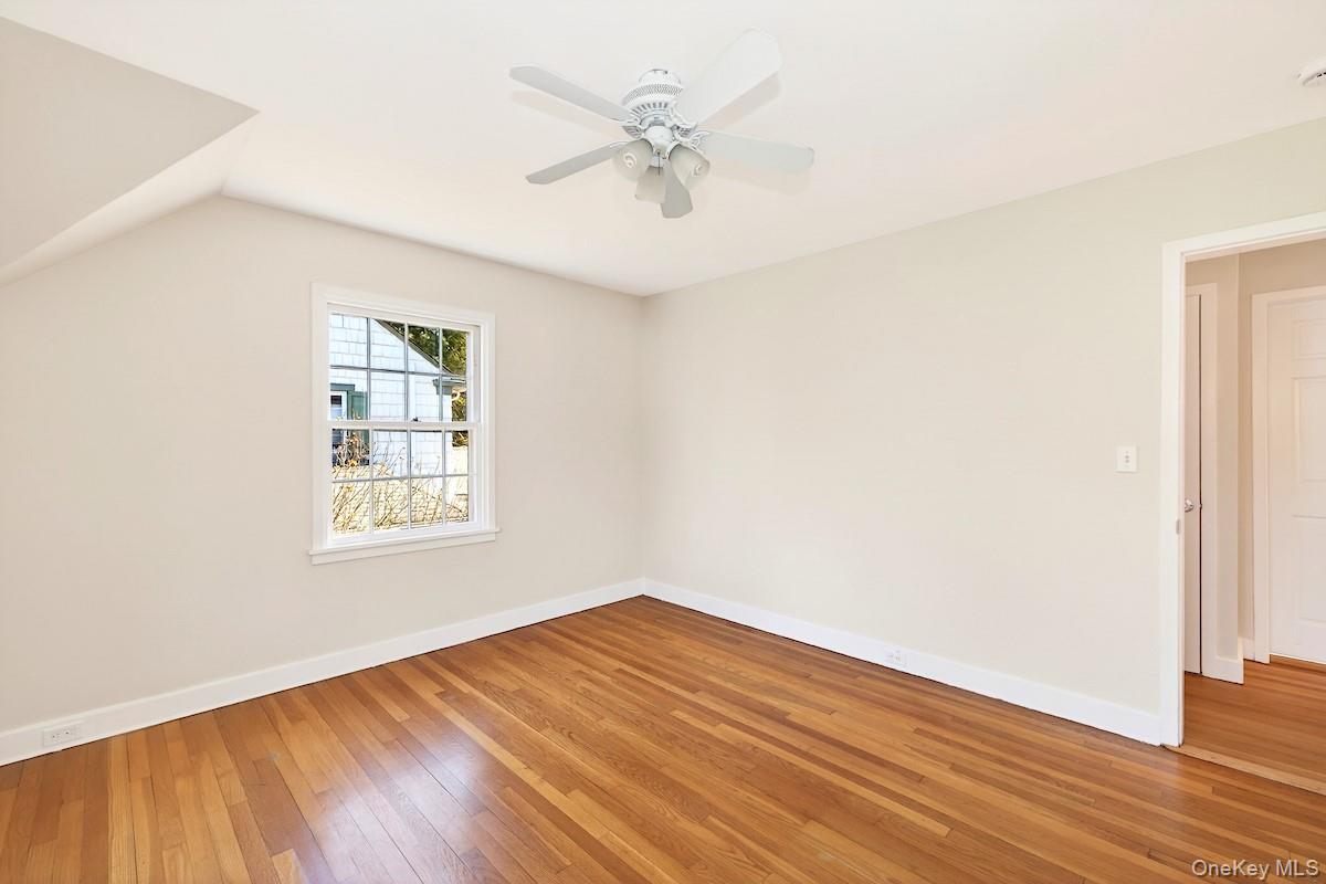 48 Fenwick Road Hastings-on-Hudson, NY 10706 - Photo 30 of 40 an empty room with wooden floor fan and windows