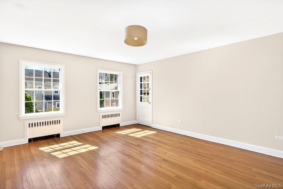 48 Fenwick Road Hastings-on-Hudson, NY 10706 - Photo 8 of 40 a view of an empty room with wooden floor and a window