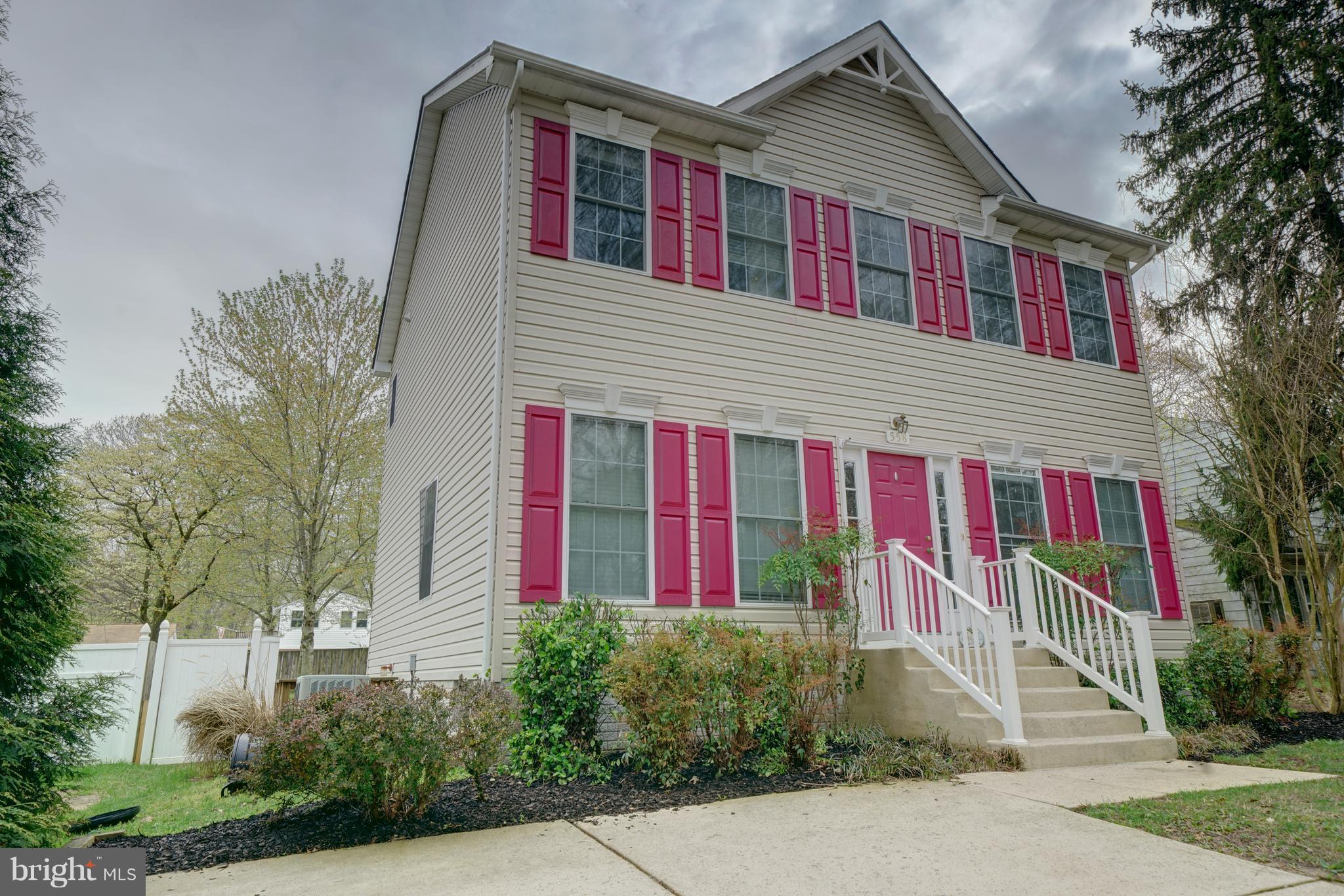 558 Sunset Knoll Road Pasadena, MD 21122 - Photo 2 of 30 a view of a house with large windows and flower plants