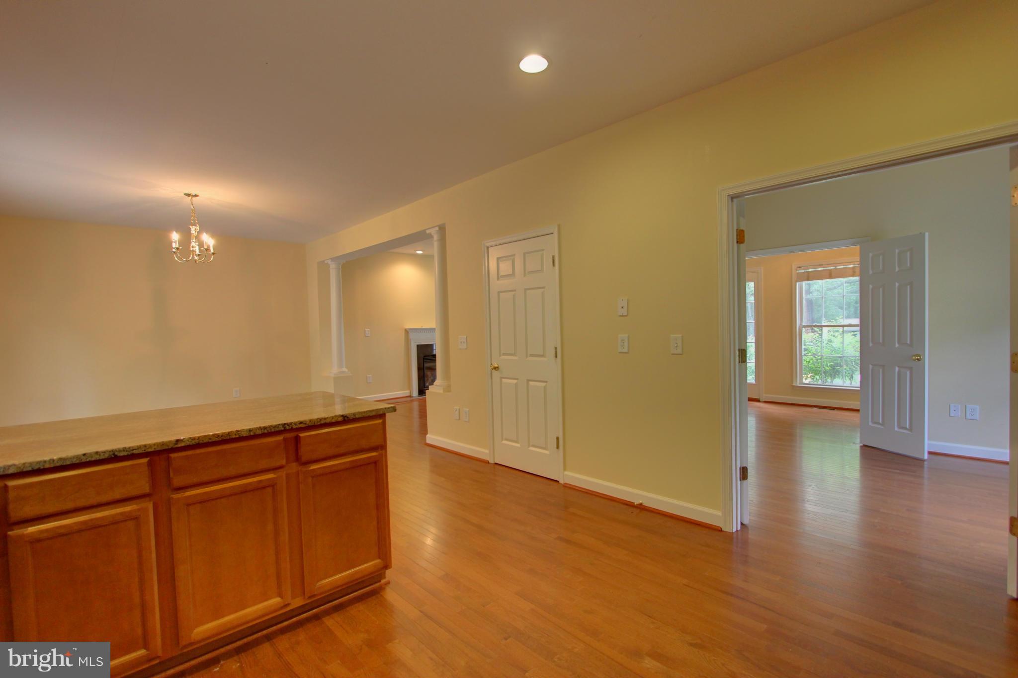 558 Sunset Knoll Road Pasadena, MD 21122 - Photo 14 of 30 an empty room with wooden floor and windows