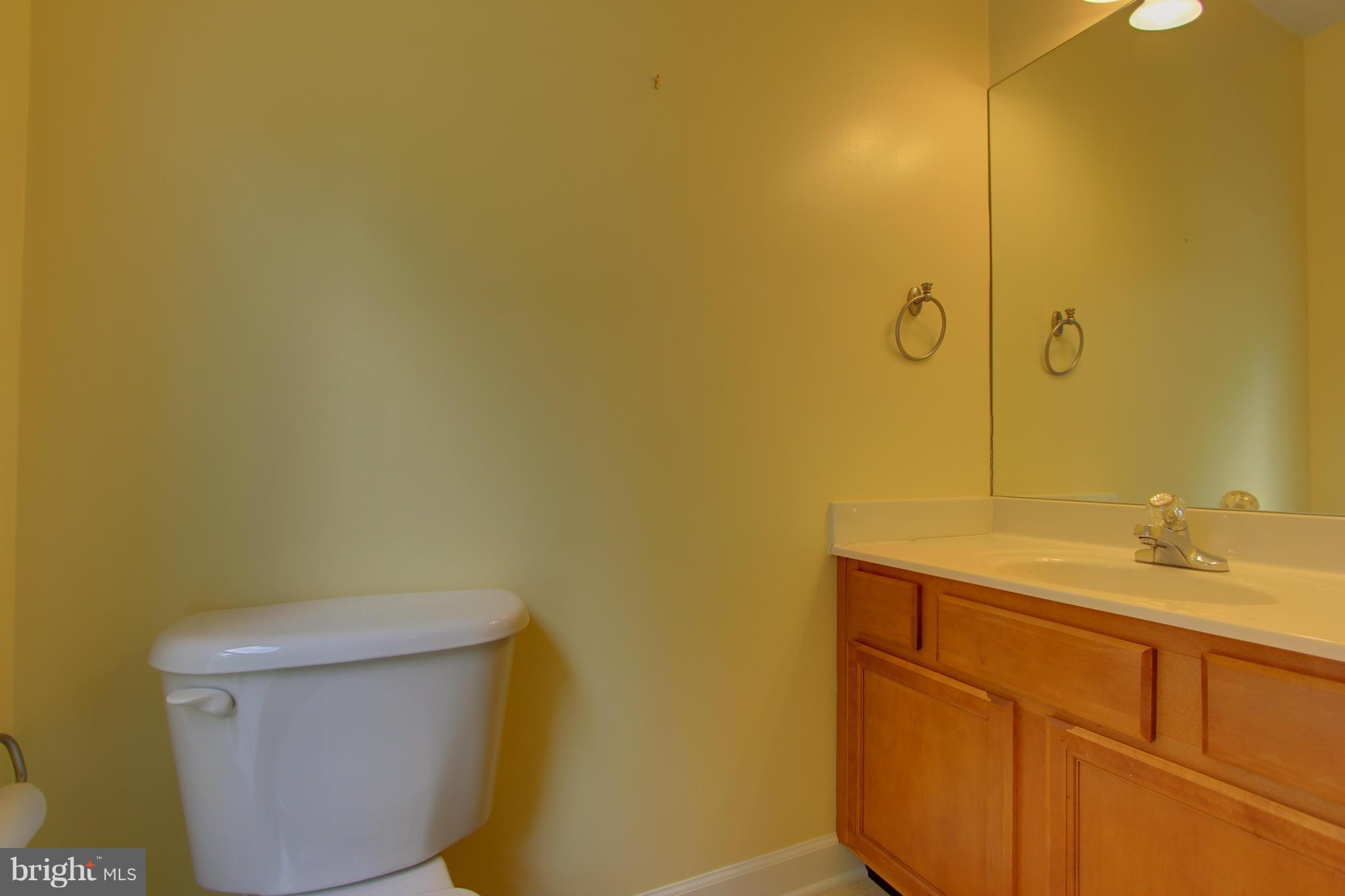 558 Sunset Knoll Road Pasadena, MD 21122 - Photo 16 of 30 a bathroom with a sink a toilet and mirror
