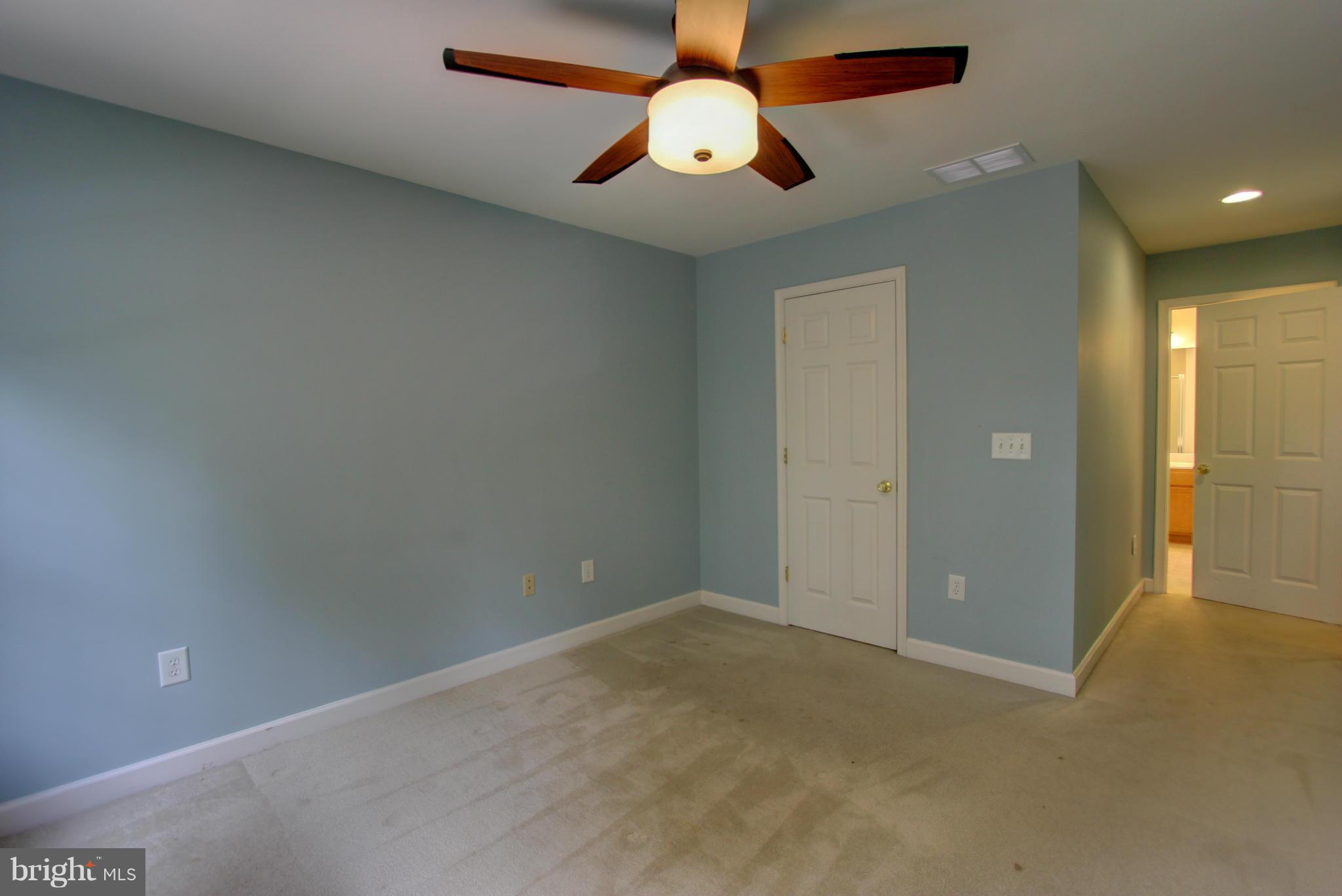 558 Sunset Knoll Road Pasadena, MD 21122 - Photo 18 of 30 an empty room with closet and a chandelier fan