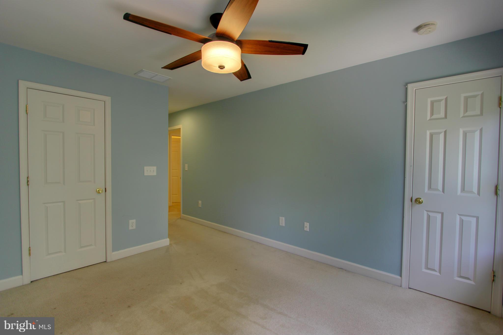 558 Sunset Knoll Road Pasadena, MD 21122 - Photo 19 of 30 an empty room with closet and a chandelier fan