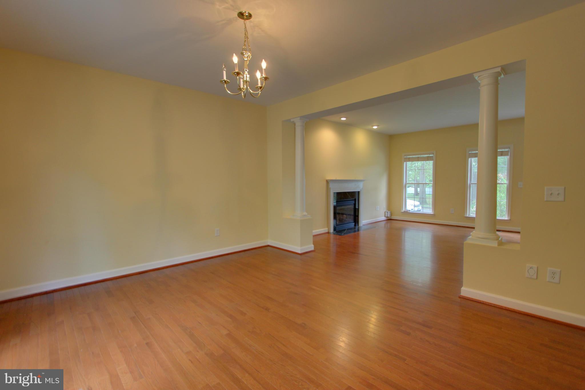 558 Sunset Knoll Road Pasadena, MD 21122 - Photo 9 of 30 wooden floor in an empty room with a window