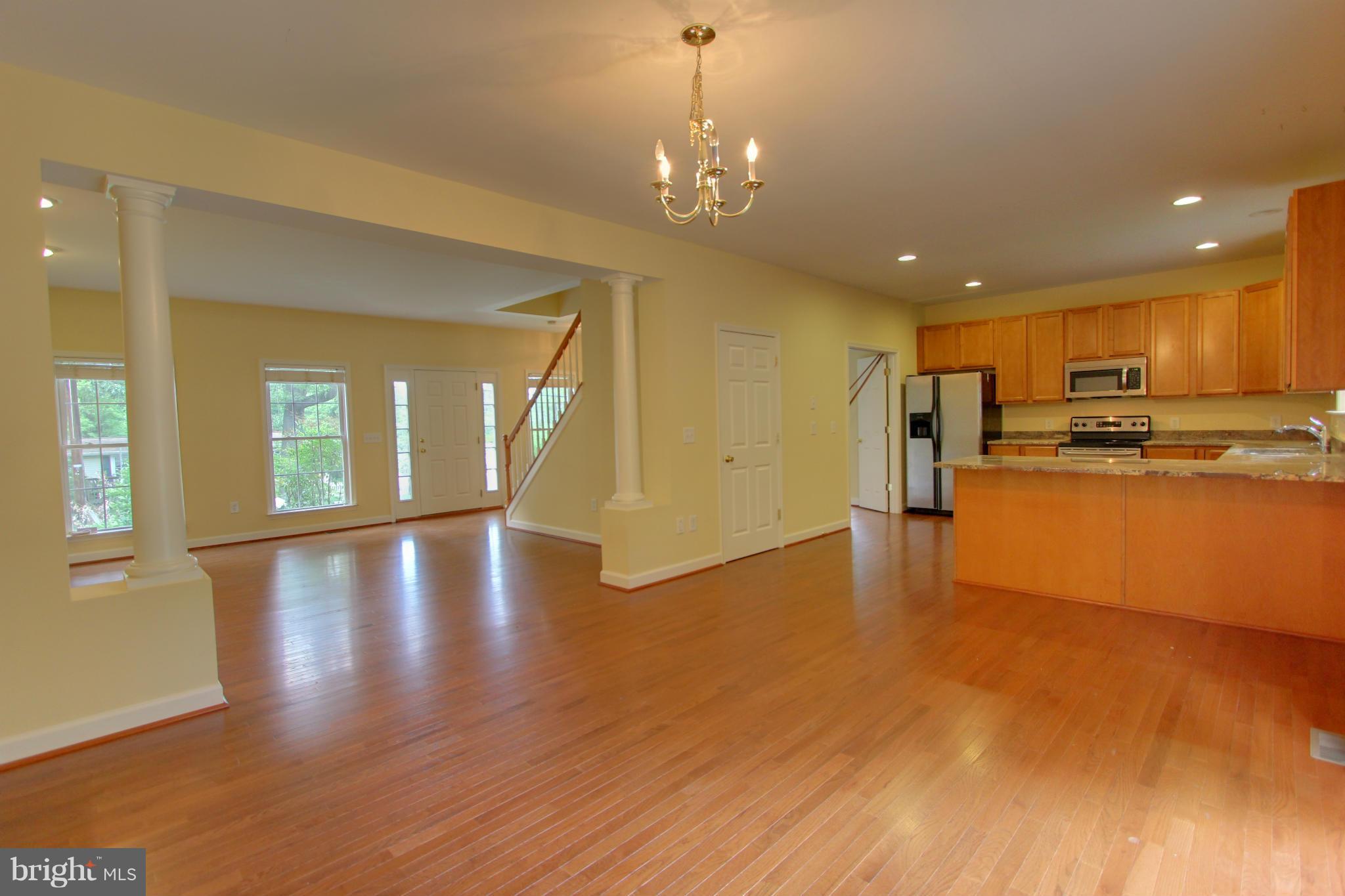 558 Sunset Knoll Road Pasadena, MD 21122 - Photo 10 of 30 a view of a kitchen and dining room with wooden floor