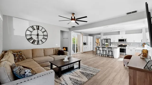 a living room with furniture and kitchen view