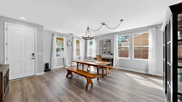 a living room with furniture a window and wooden floor