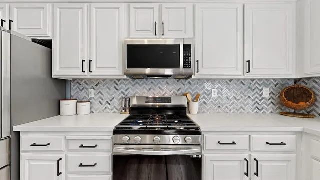 a stove top oven sitting inside of a kitchen