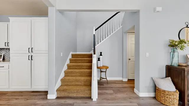 a view of entryway with wooden floor and stairs