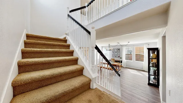 a view of entryway and hall with wooden floor