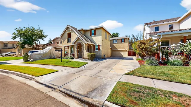 a front view of a house with a yard table and chairs