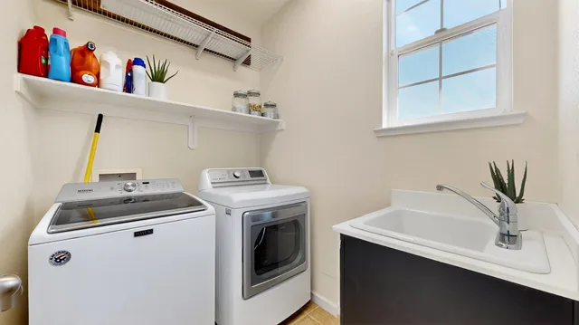 a bathroom with double vanity sink a mirror and shower