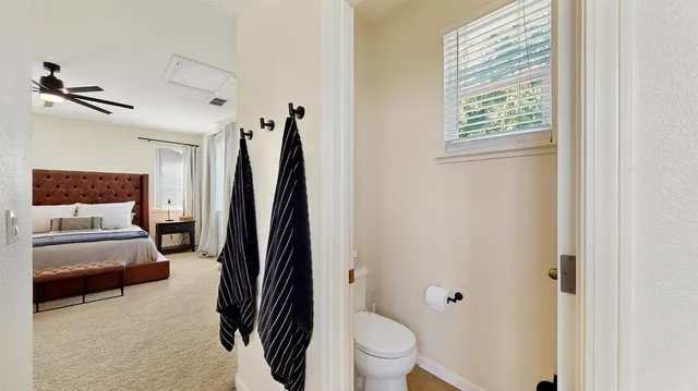 a white vase with flowers sitting on a table