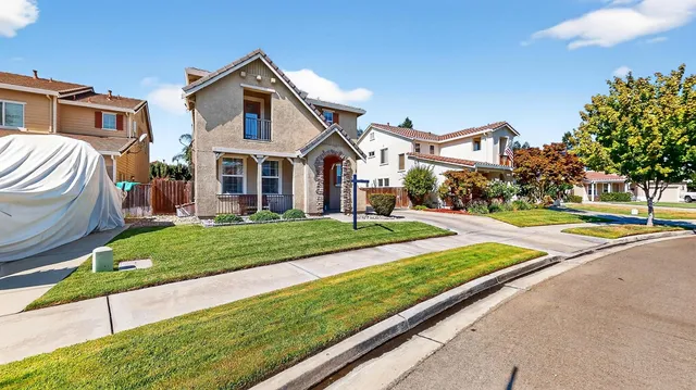 a front view of a house with a yard table and chairs