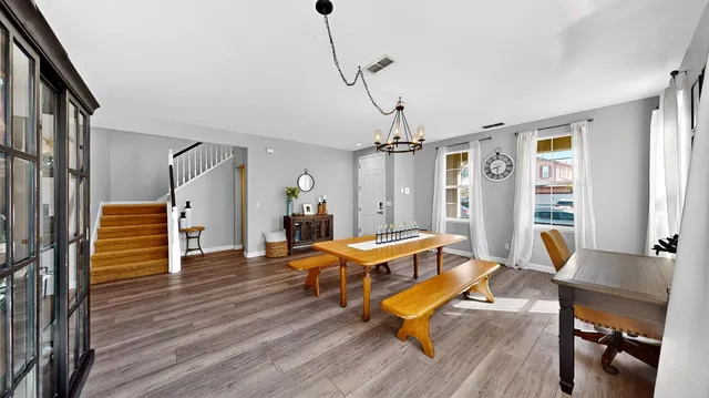 a living room with furniture a table and wooden floor