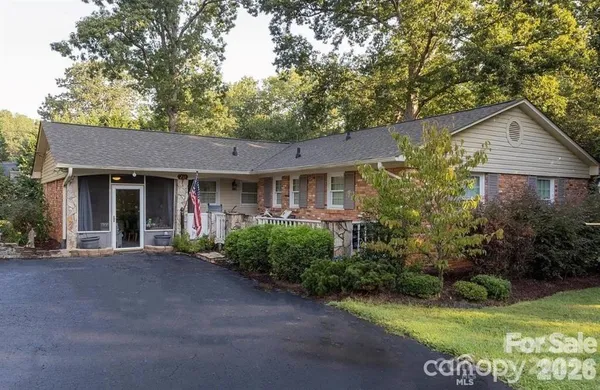 a front view of a house with a garden and yard