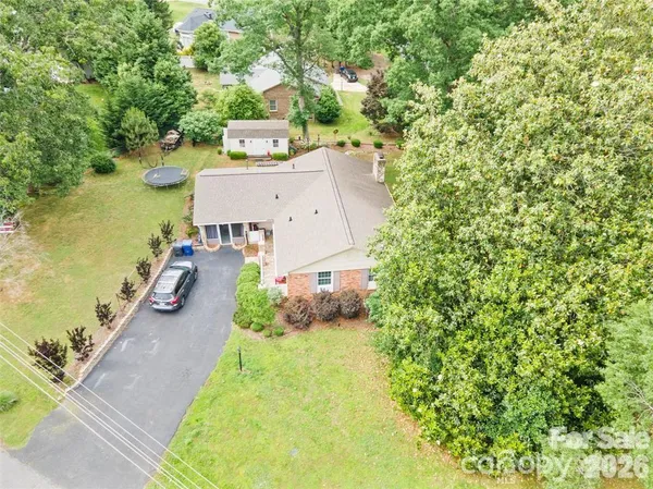 an aerial view of a house with a garden and swimming pool